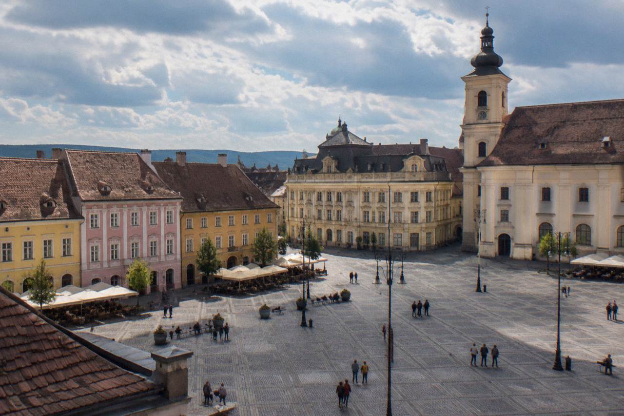 Colourful historic houses with attic windows overlooking a large square in Sibiu
