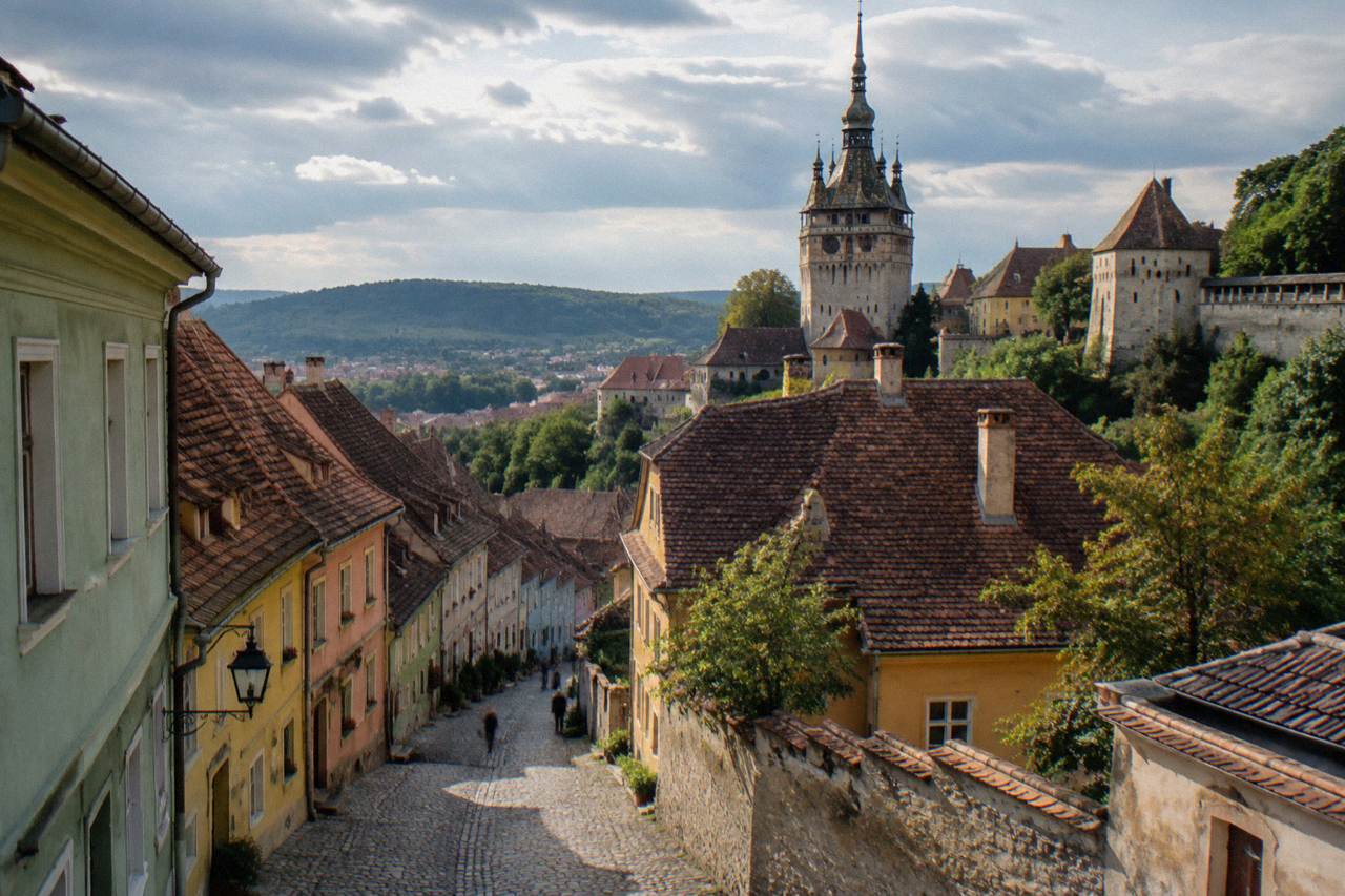 Colourful centuries-old houses along a cobbled street in the walled old town of Sighișoara