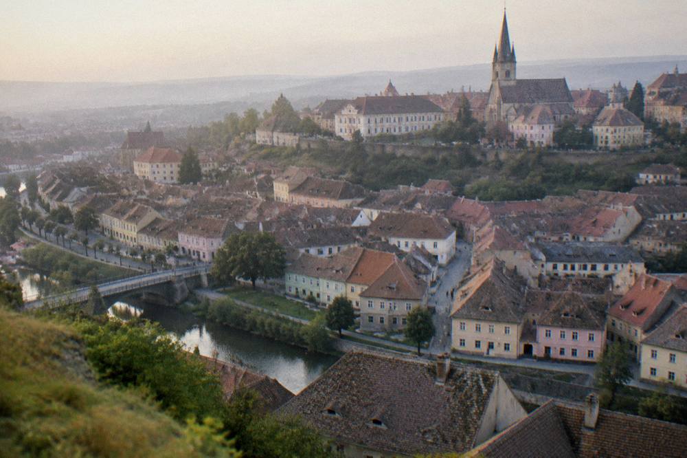 The rooftops of Sibiu's Lower Town seen from a hill across the Cibin valley at dusk