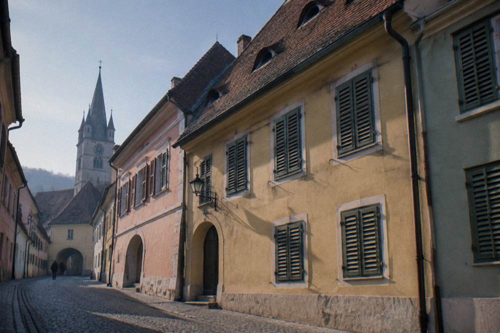 Guesthouse facade with shuttered windows on a calm street in eastern Sibiu