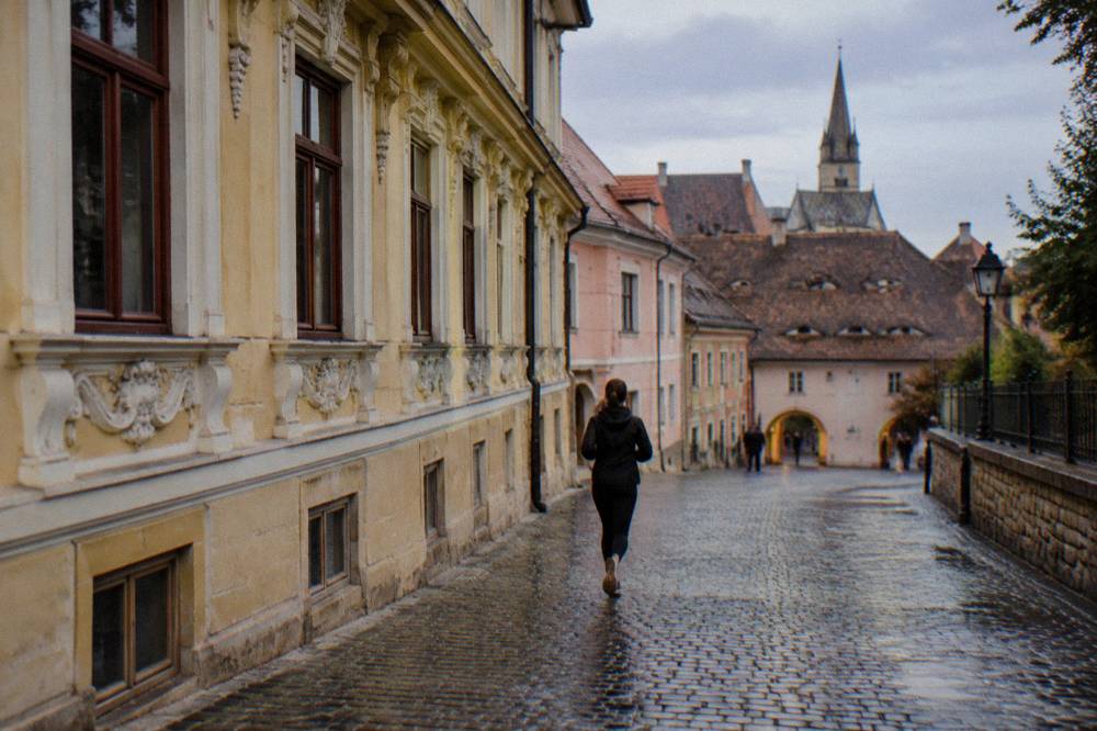 Detail of an ornate historic building cornice and window frames on a street in Sibiu