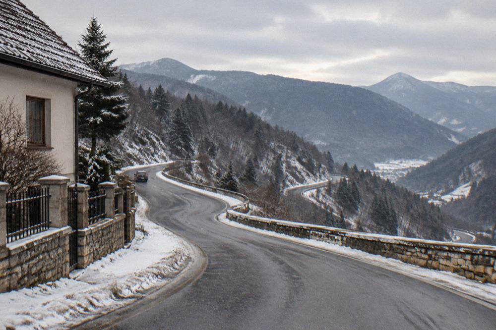 Winding mountain road with switchbacks climbing towards high ridges in the Făgăraș range