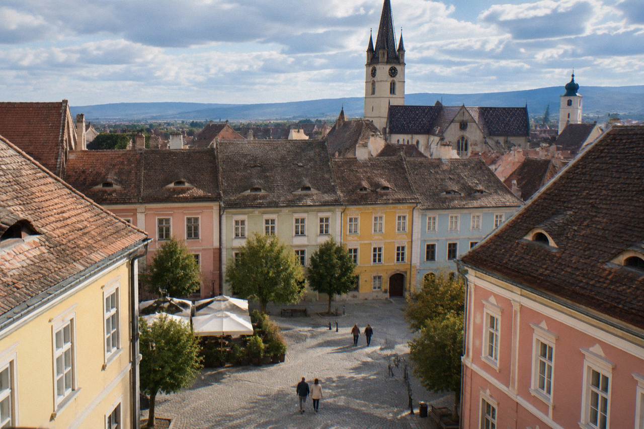 Colourful baroque facades and church spires above the rooftops of Sibiu's Upper Town