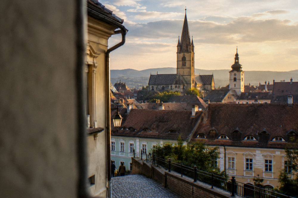 Warm evening light on the rooftops and church towers of a Transylvanian old town