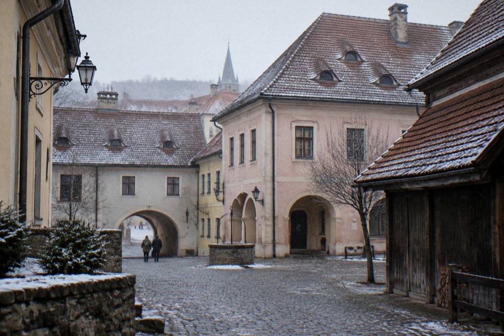 The courtyard of an old Saxon house in the centre of Sibiu contrasted with rural timber buildings
