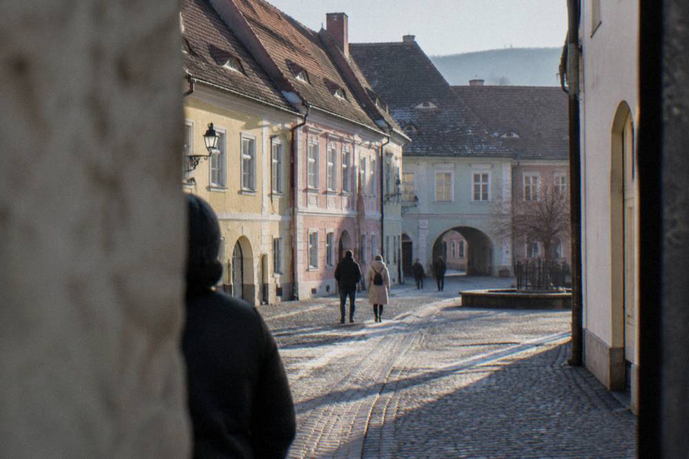 A Sibiu old town street with pastel-coloured burgher houses and the 'Eyes of Sibiu' roof windows