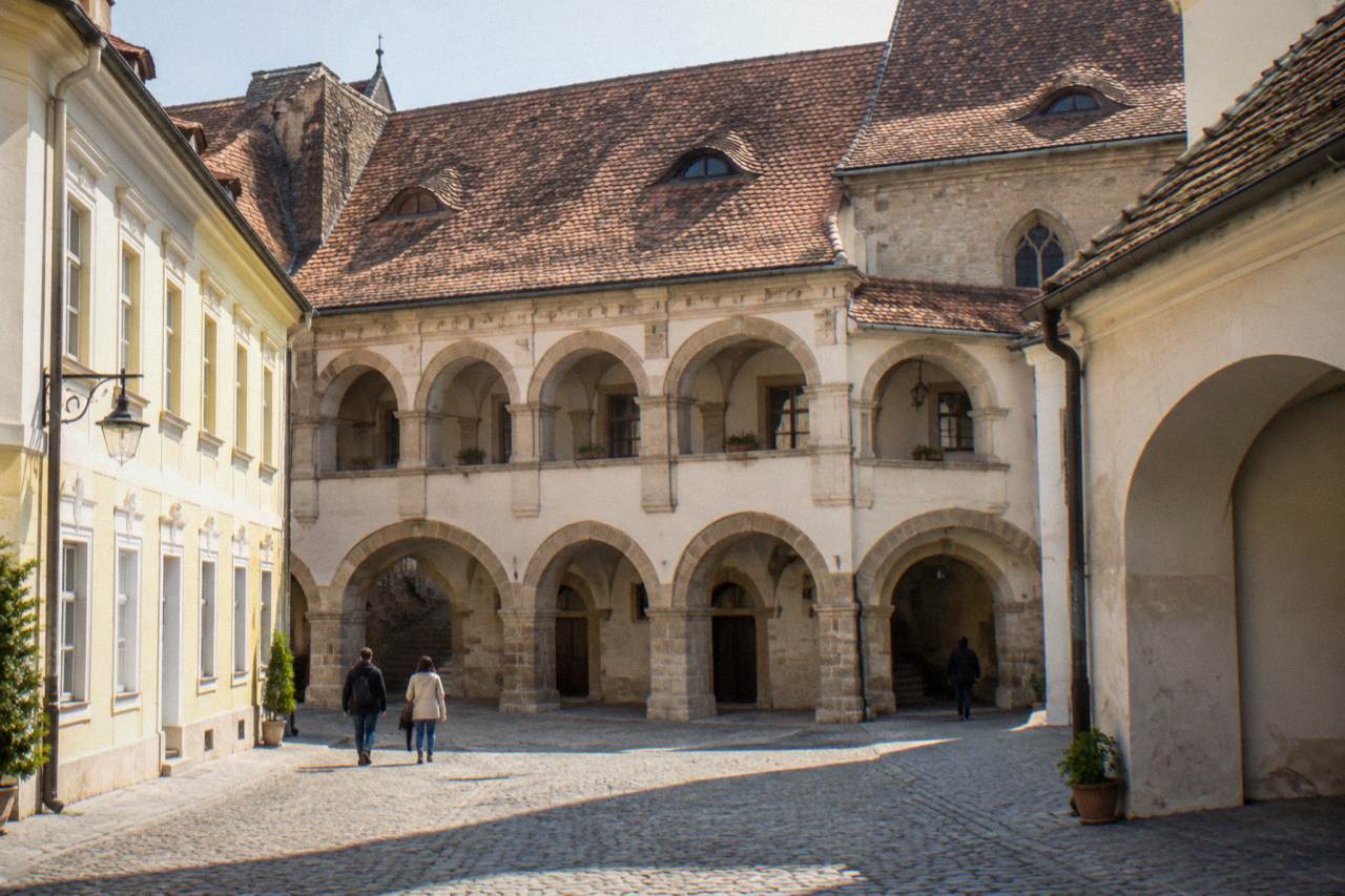 The stone arches and courtyard facade of the Altemberger House in Sibiu's old town