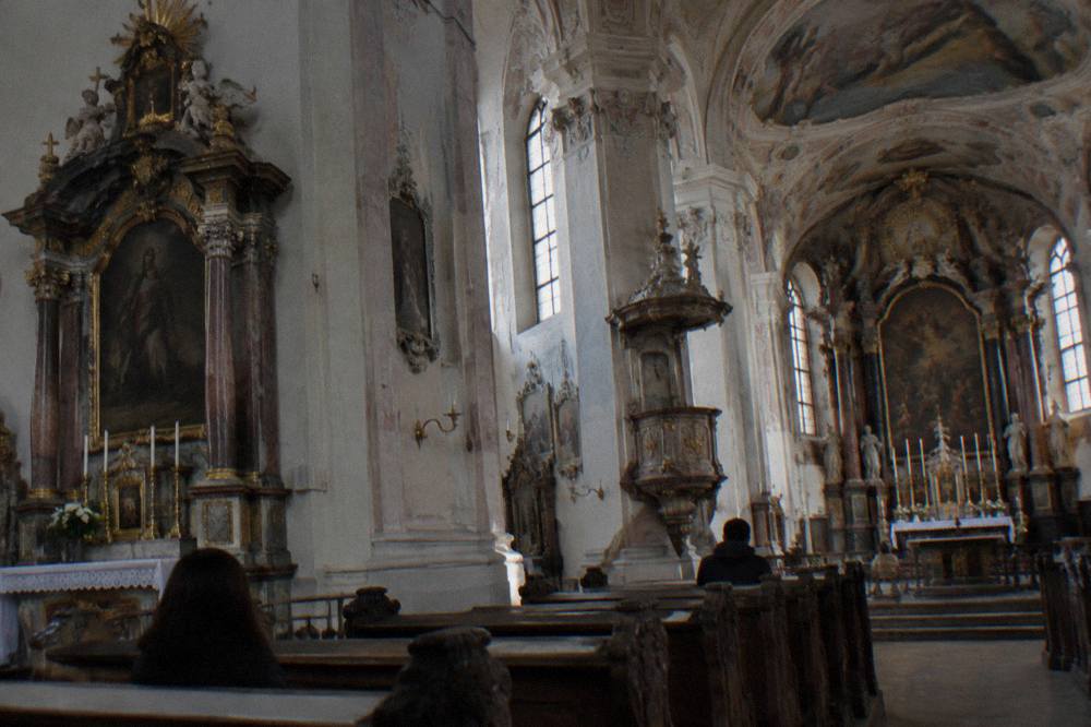 Interior of a baroque Catholic church with columns, altars and painted decoration
