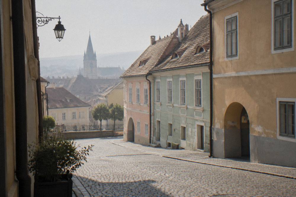 A quiet street corner in the Lower Town of Sibiu with pastel coloured houses