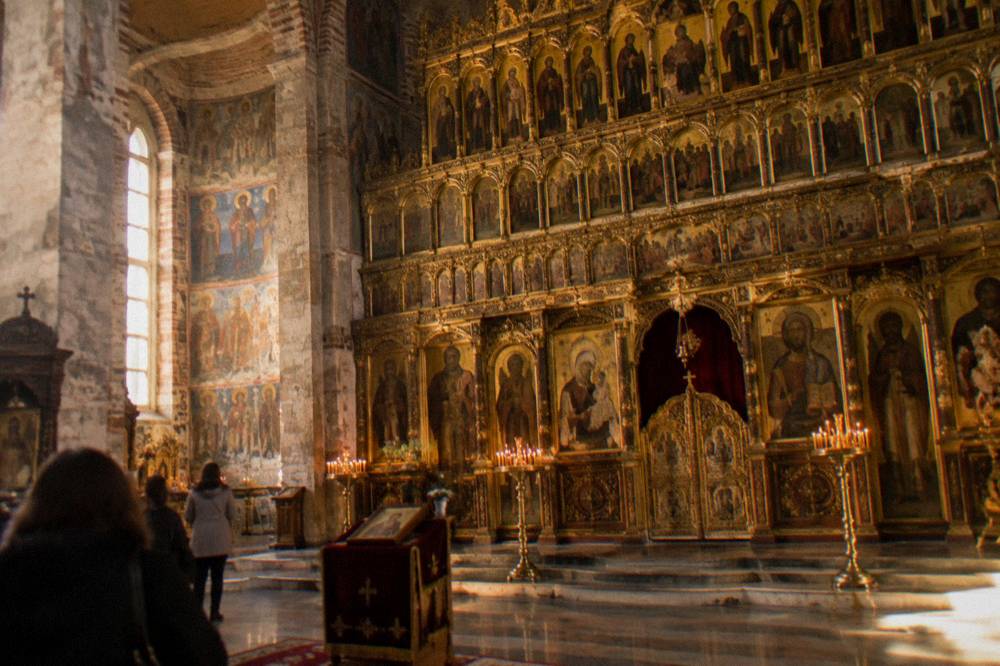 Gilded iconostasis with tiers of icons inside an Orthodox cathedral