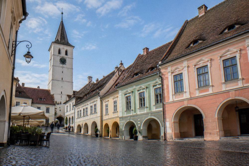 The facade of a historic building on a small square in Sibiu's old town