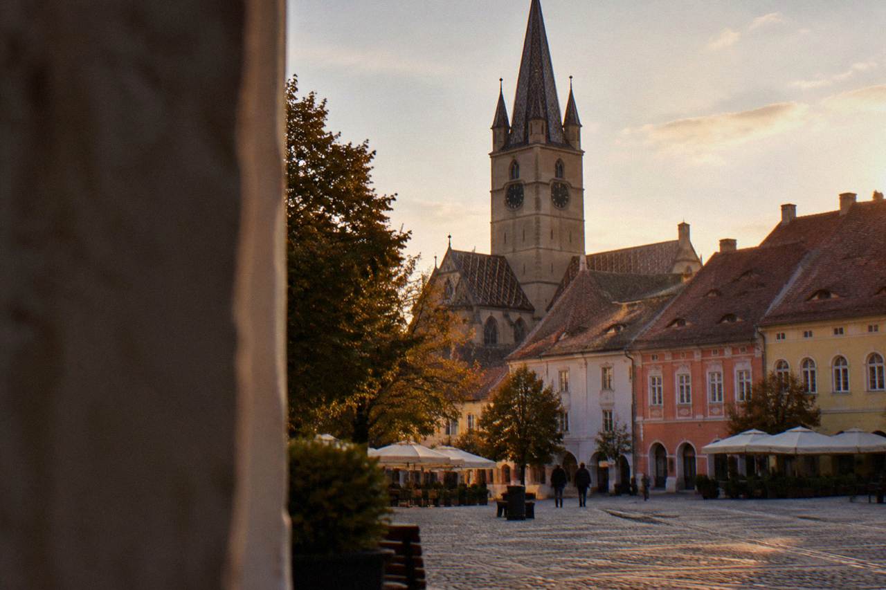 The Gothic tower of the Evangelical Cathedral rising above the colourful historic houses of Huet Square in Sibiu