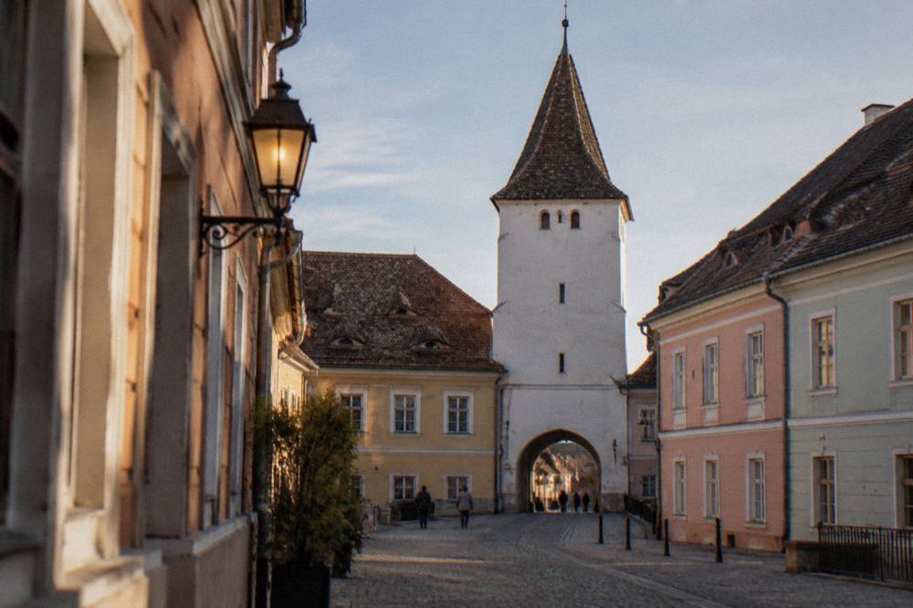The Council Tower rising at the end of a narrow street beside the Small Square in Sibiu
