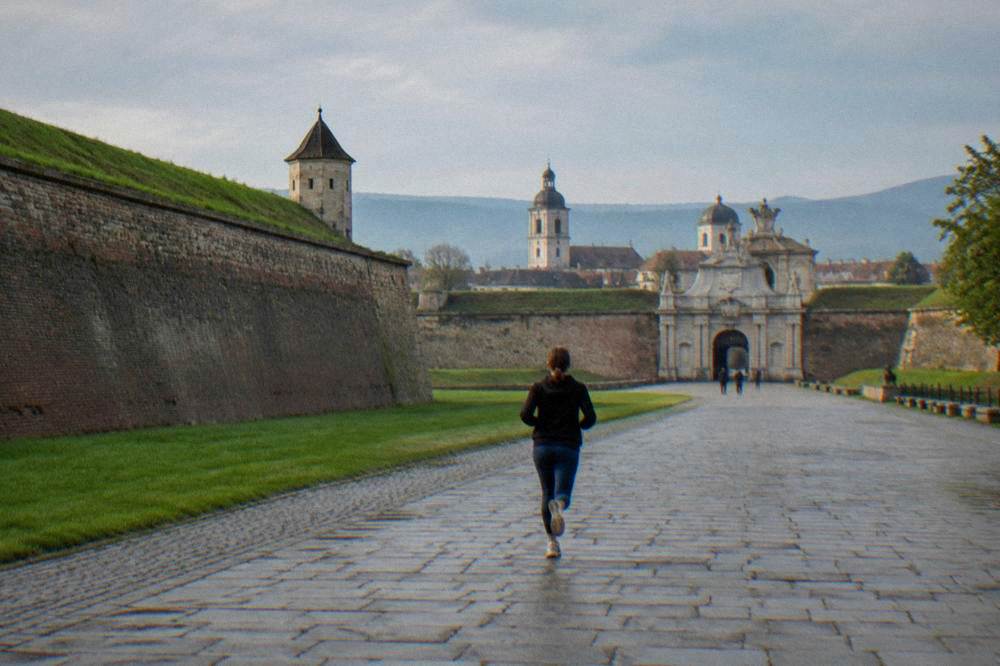 A star-shaped fortress gate opens onto a wide lawn.