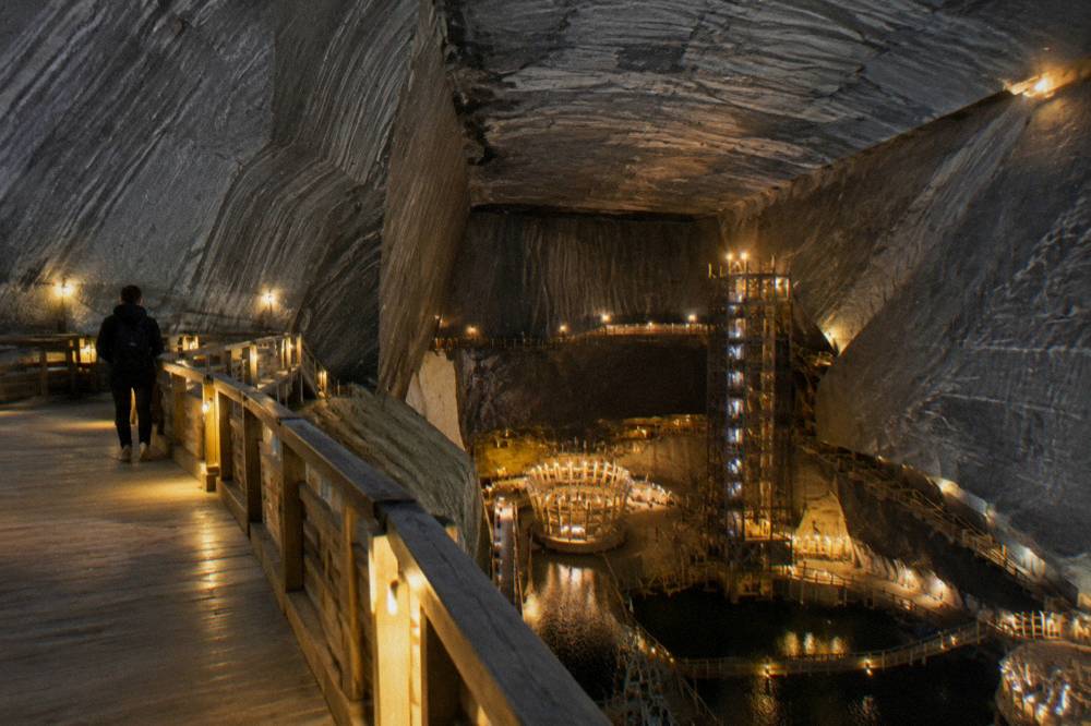 Underground chambers of a historic salt mine lit with warm amber lighting