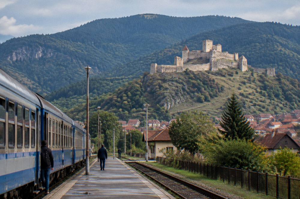 A regional train standing at a small Romanian railway station platform