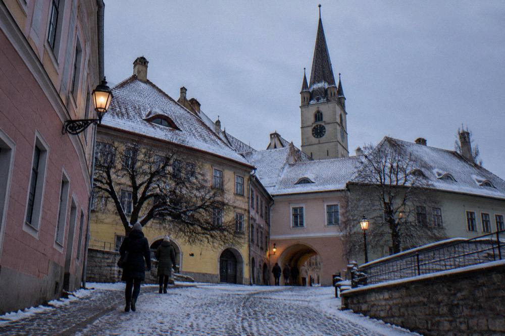 Snow-covered rooftops of Sibiu old town under a winter sky