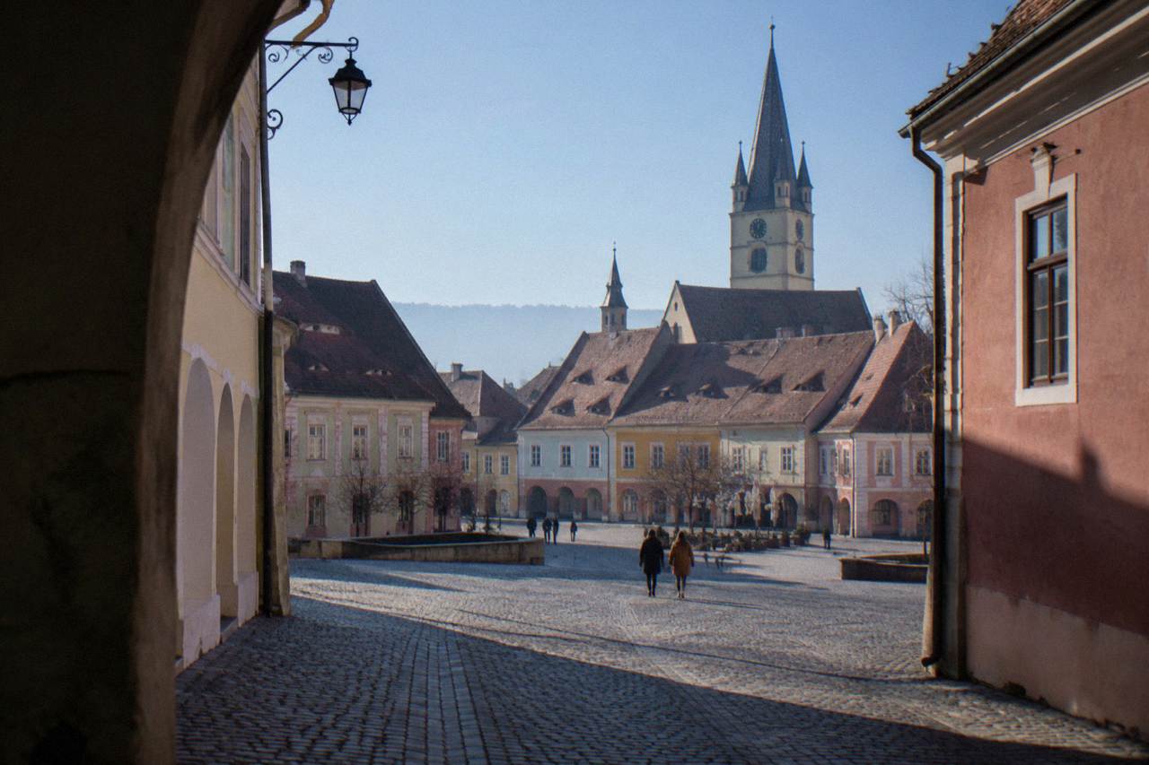 Colourful historic houses and church spires of Sibiu old town under a clear blue sky