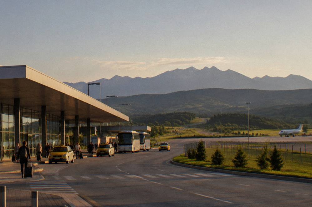 A road winding through green hills toward the Făgăraș mountains of Transylvania