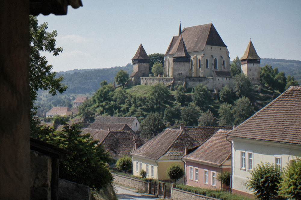 Biertan fortified church on a hill, its defensive towers and walls above the village roofs