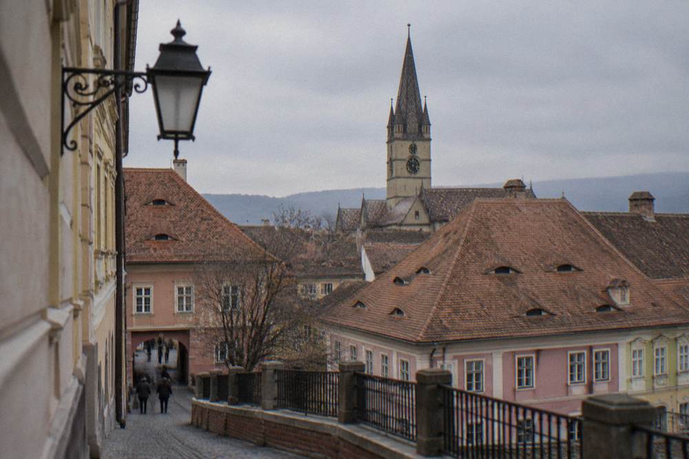 A gothic church tower rising above the rooftops of Sibiu's old town