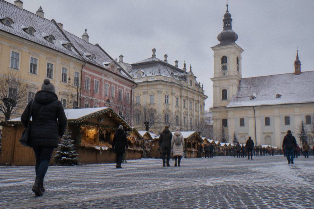 Wooden market chalet with garlands and festive lights in a Transylvanian town square
