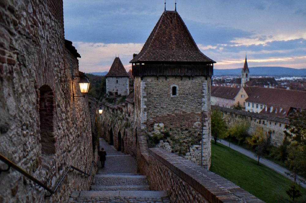 A stone staircase passage between medieval walls connecting two levels of an old town