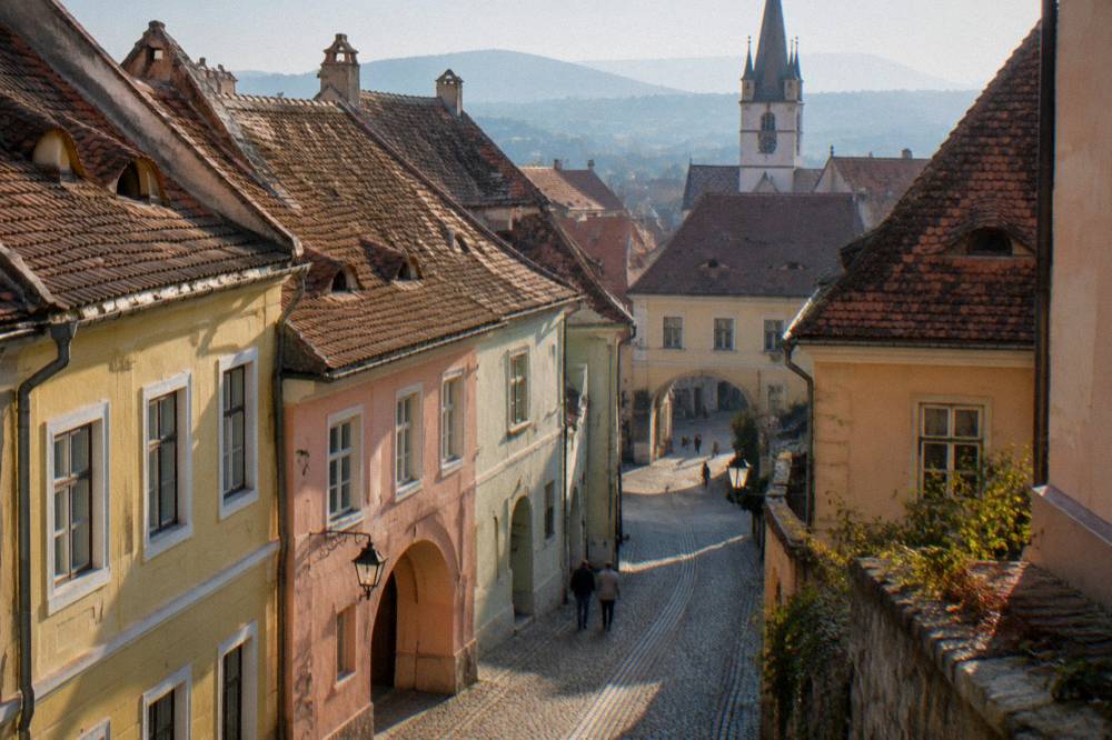 Narrow old lane in the Lower Town of Sibiu with pastel houses and arched passages