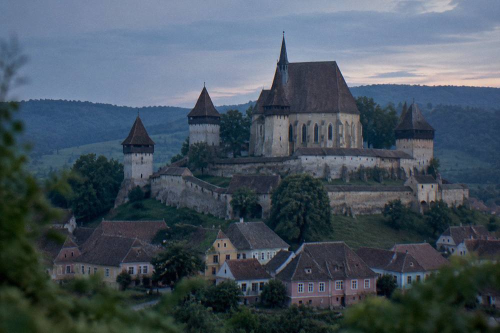 Fortified church with tall defensive walls in a Transylvanian village