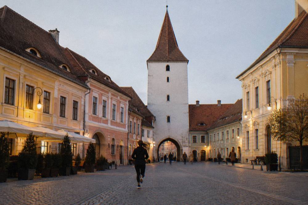 The Council Tower and colourful building facades lining the grand square of Sibiu