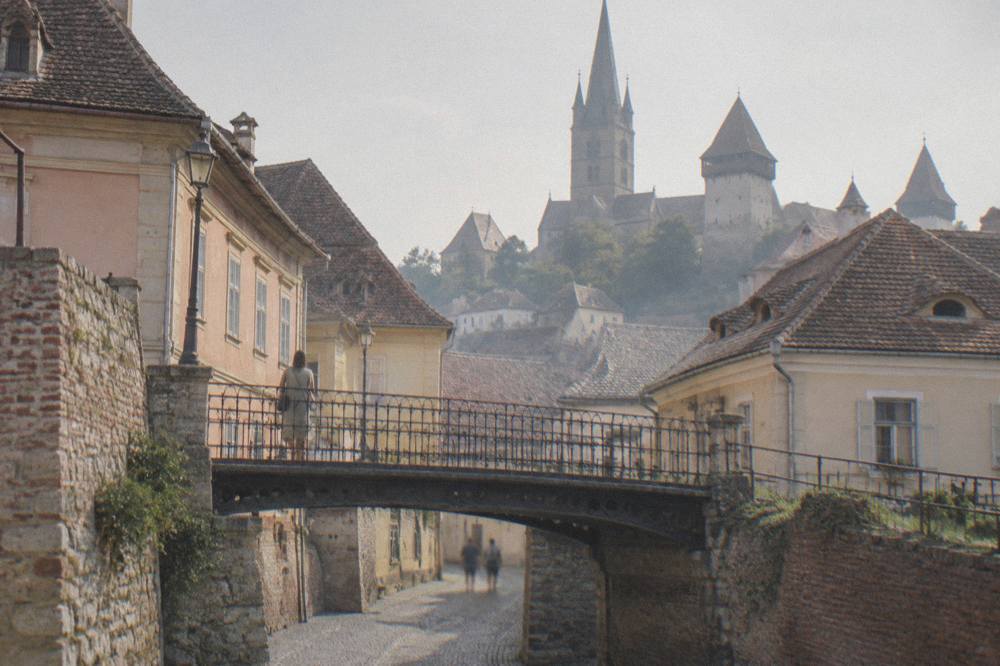 A fortified Saxon church with defensive towers standing above a Transylvanian village