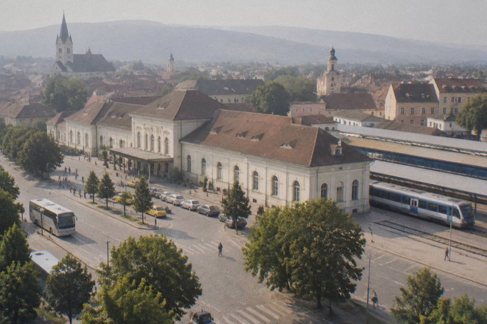 A regional train waiting at a small Romanian railway station platform