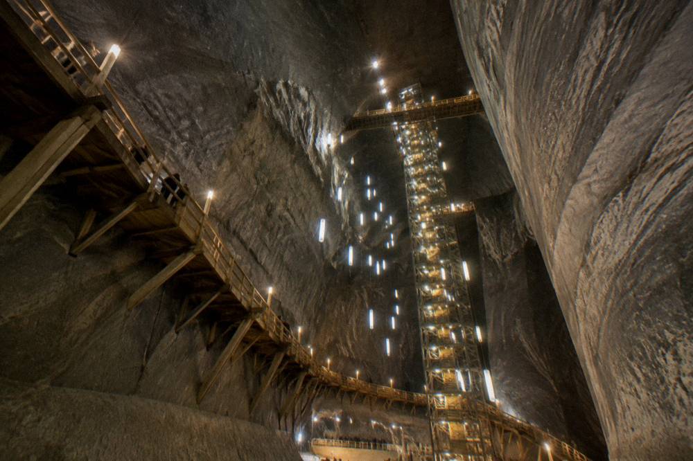 An underground chamber of a Romanian salt mine lit with warm light