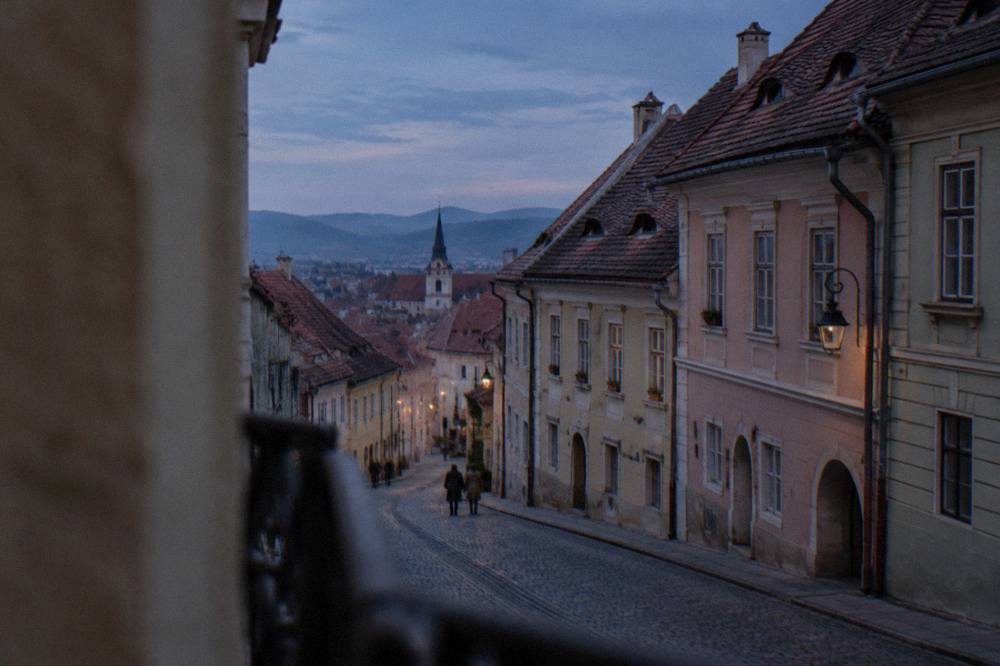 A street leading from Sibiu train station towards the old town with pastel-coloured buildings