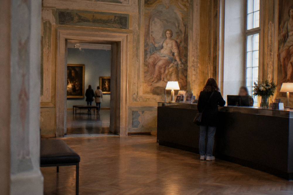 A ticket counter and painted gallery walls inside a baroque art museum