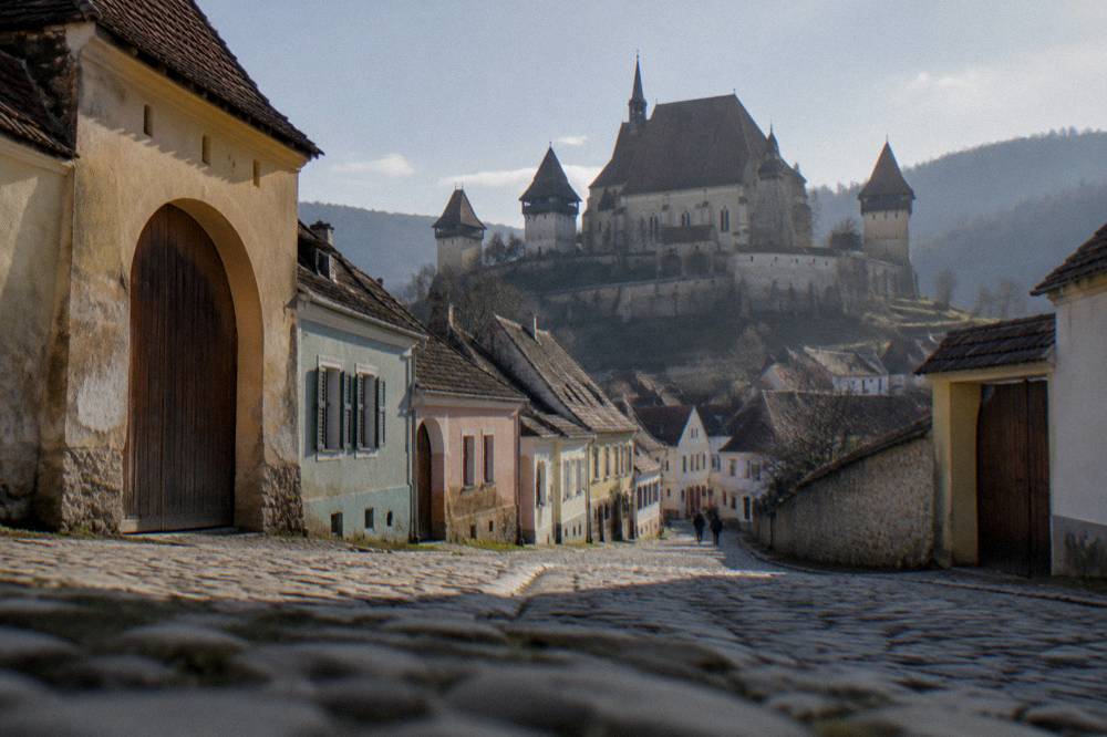 Street of old Saxon houses with tall gates in a fortified Transylvanian village