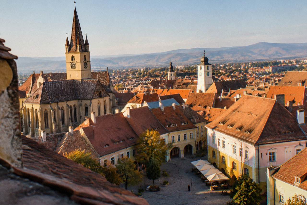 The towers and red roofs of Sibiu old town seen from above on a clear day