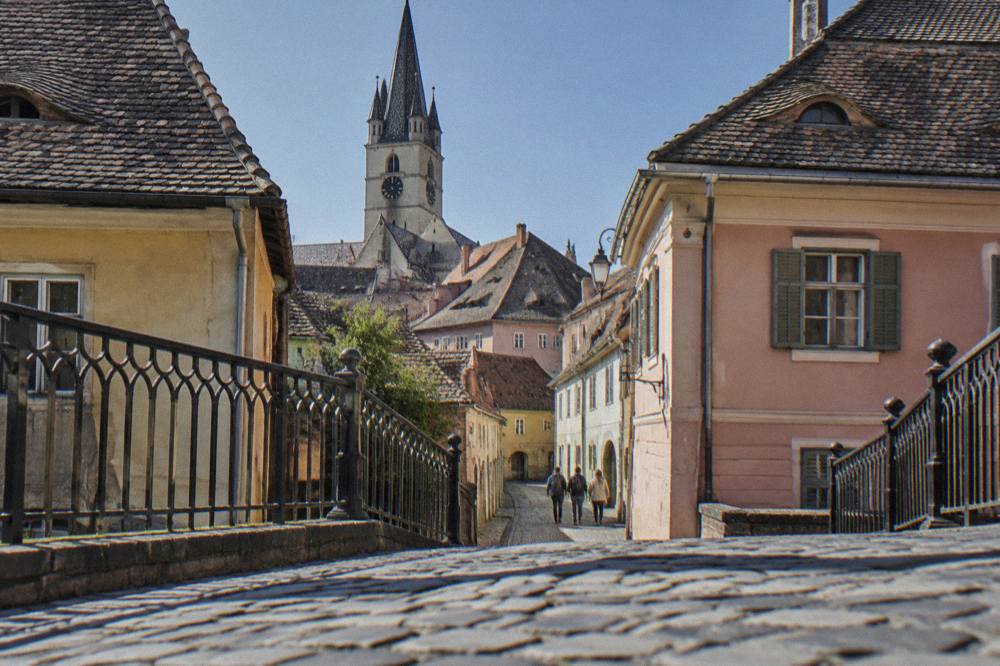The Bridge of Lies, an iron pedestrian bridge crossing above a lane in central Sibiu
