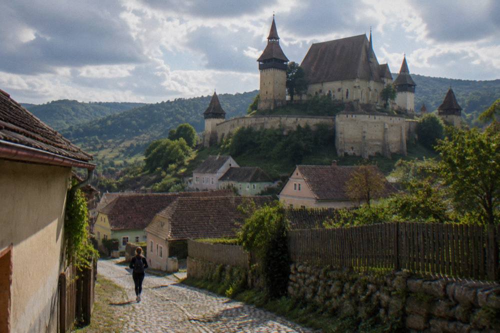 Fortified church tower rising above a Saxon village in the hills near Sibiu