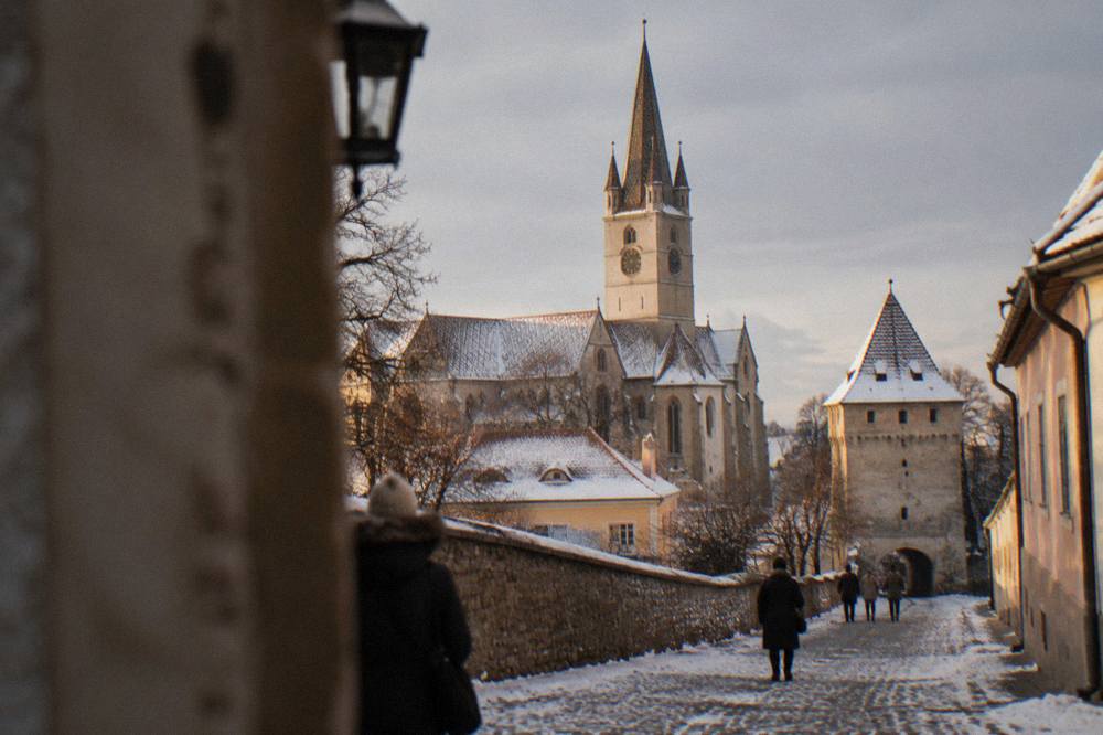 Snow-covered lane in Sibiu's Lower Town leading to one of the old defensive towers