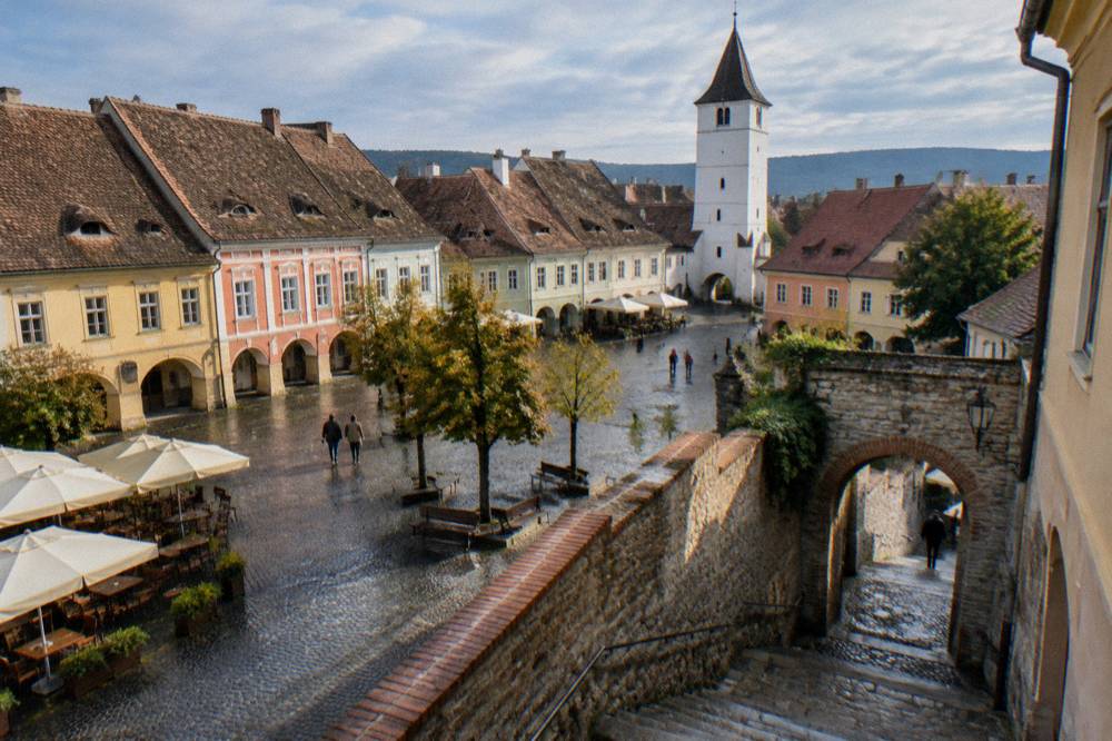 A stone staircase and archway leading between old walls in Sibiu's lower town