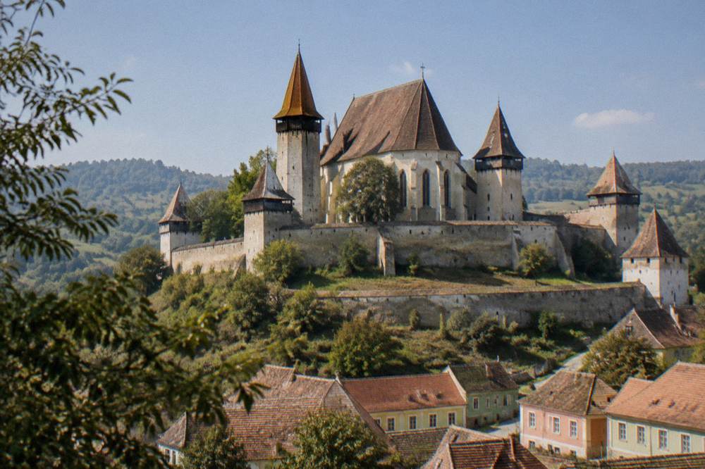A fortified church with tall defensive walls in a Transylvanian Saxon village